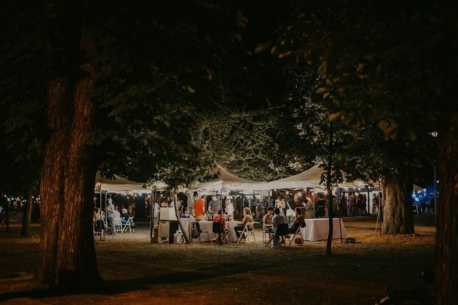 Elegant white marquee tent illuminated at twilight for a luxury outdoor event