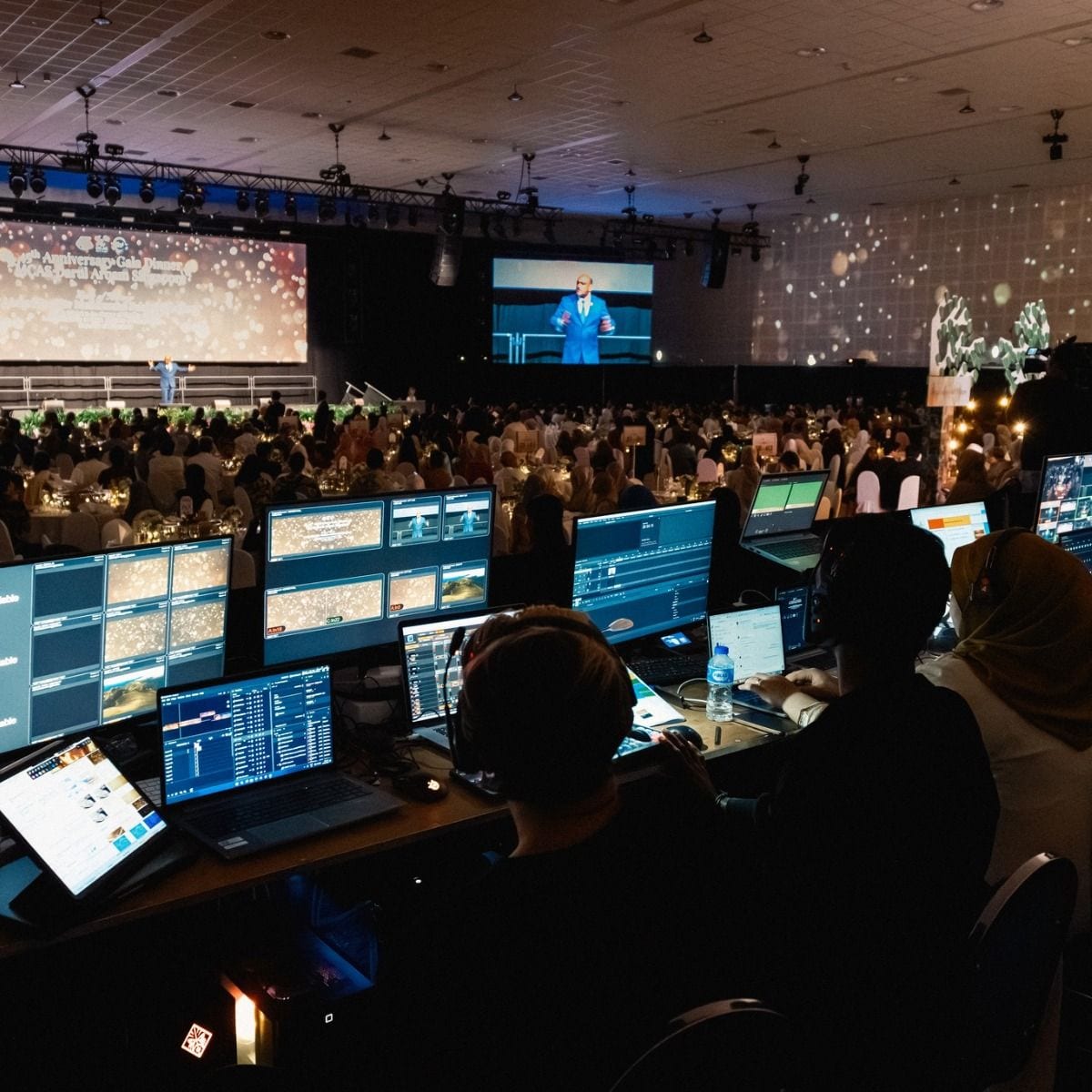 Indoor event venue setup with elegant lighting and staging